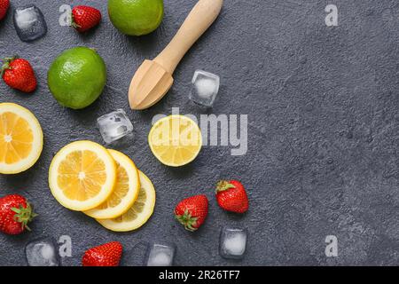 Juicer and ingredients for preparing strawberry lemonade on black background Stock Photo