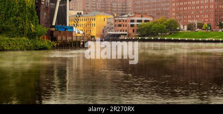 Early morning mist rises on a bend of the Cuyahoga river in downtown Cleveland, Ohio Stock Photo