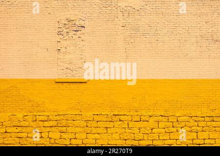 An old brick wall in Cleveland, Ohio, painted yellow Stock Photo