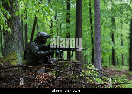 Slovak soldiers assigned to the Slovakian 22nd Mechanized Infantry Battalion patrol during Exercise Combined Resolve 18  at Hohenfels Training Area, Joint Multinational Readiness Center, Germany, May 11, 2023. Combined Resolve 18 is a U.S. Army exercise, consisting of over 4,000 service members, allies, and partners from 15 countries, and is designed to assess units' abilities to conduct combat operations effectively in a multi-domain battlespace. (U.S. Army photo by Sgt. Christian Aquino) Stock Photo