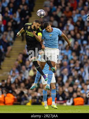 Manchester, UK. 18th May, 2023. Real Madrid's captain Karim Benzema (L) challenges for a header with Manchester City's Rodri during the UEFA Champions League semifinal 2nd Leg match between Manchester City and Real Madrid in Manchester, Britain, on May 17, 2023. Credit: Xinhua/Alamy Live News Stock Photo