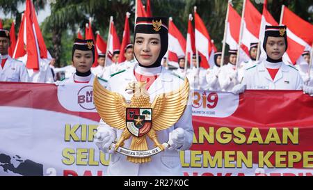 Indonesian holding Garuda Pancasila (Indonesian five principles) Stock Photo