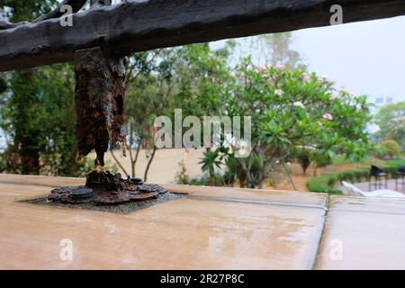 Metal posts containing iron showing corrosion and rust in humid conditions and weather; metal bars destroyed, eroded and eaten away by coastal air. Stock Photo