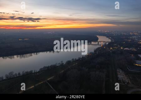 Cremona, Italy - January 2023 Sunset in plain near the city, Po bridge connecting Emilia Romagna and Lombardy Stock Photo