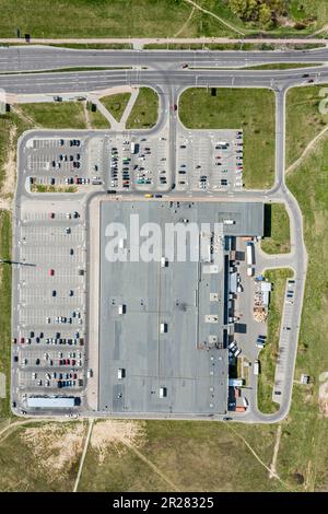 aerial drone view of a parking lot with parked cars near supermarket in suburb area Stock Photo