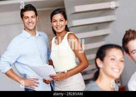Thriving through teamwork. Portrait of two creative directors smiling at you while discussing a project brief. Stock Photo