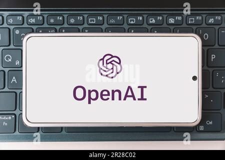 OpenAI logo seen on screen smartphone and laptop. Open AI - American company engaged in the development and licensing of machine learning-based techno Stock Photo