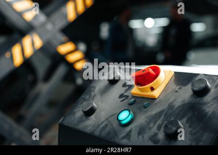 Control panel of a car lift hoist crane in auto service garage Stock Photo