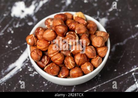 Hazelnut. Peeled hazelnuts in ceramic bowl. Superfood. Vegetarian Food concept. Healthy snacks. Close up Stock Photo