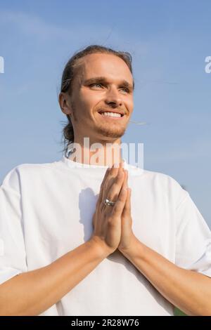 Happy man under sakura tree looking upwards. Happy smiling senior man  looking up. Old man positive and optimistic. Good mood. Positive emotions.  Happy old age. Cheerful pensioner. Mental health Stock Photo by ©