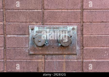 Old standpipe fire department connection Stock Photo