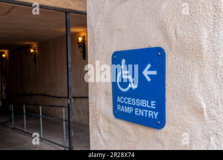 Ramp way with the accessible ramp entry sign for disabled Stock Photo