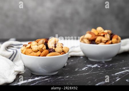 Mixed nuts. Special mixed nuts in a ceramic bowl. Nuts, pistachios, peanuts, cashews, almonds. superfood Vegetarian food concept. healthy snacks Stock Photo