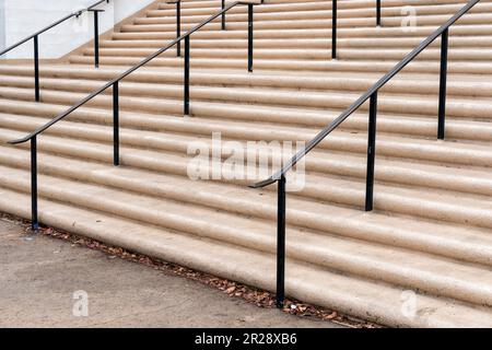 Old concrete staircase with metal handrails Stock Photo