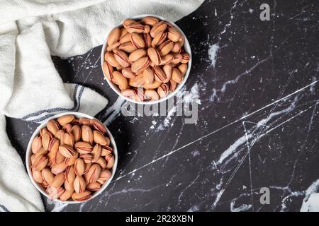Pistachio. Pistachios in ceramic bowl. superfood. Vegetarian food concept. healthy snacks. Top view. Copy space. Empty space for text Stock Photo