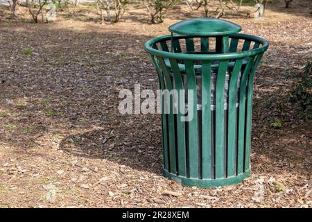 A green trash can in the park Stock Photo