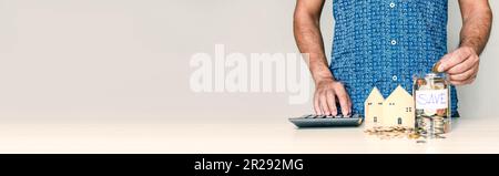 Close-up a man's finger pressing a calculator on wooden table in an office. Concept calculates bank interest money for customers who need loans, blurr Stock Photo