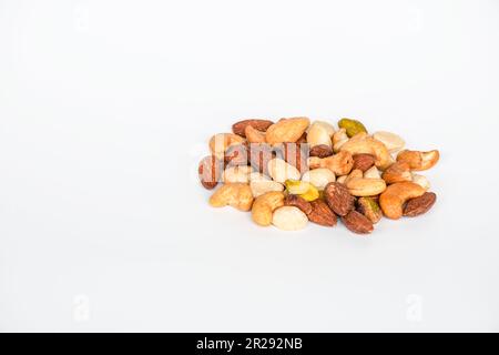 Concept, trail mix day. trail mix placed on a white floor table. Closeup. copy space on left for design or text. White background. Stock Photo