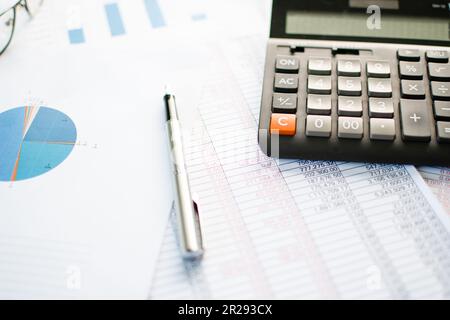 Financial accounting, Close-up calculator and numbers on paper, Many numbers, graph, pen, glasses on paper, Documents placed on the table in the offic Stock Photo