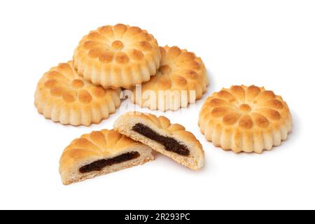 Traditional fresh baked whole and halved Maamoul cookies stuffed with dates and cardamom close up isolated on white background Stock Photo