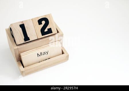 Wooden perpetual calendar showing the 12th of May Stock Photo