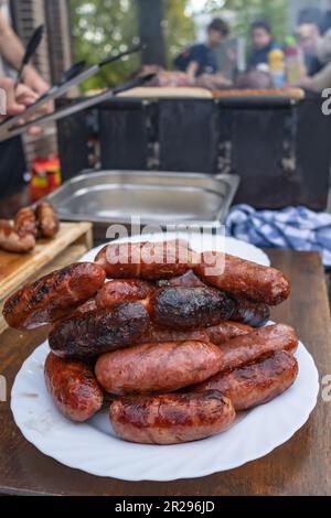 grilled chorizo ​​sausages on white plate outdoors Stock Photo