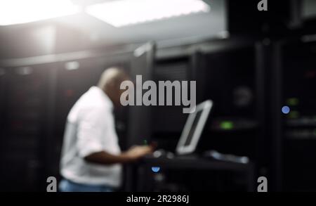 Code, black man or coding on computer in server room for big data, tech glitch or digital website. IT support, blurry or technician typing on laptop Stock Photo