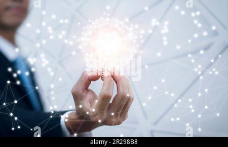 The Man hand holding light bulb with line connect and working on the desk, Creativity and innovation are keys to success.Concept of new idea and innov Stock Photo