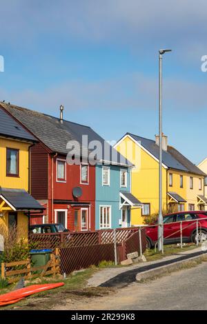 Bright coloured cladding on houses at Burravoe in the south of the island of Yell, Shetland. Stock Photo