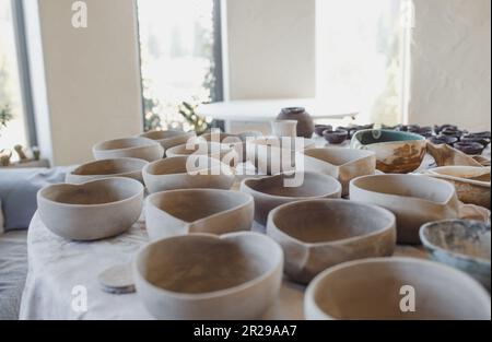 clay plates on the table, pottery work. Stock Photo