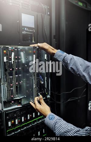 Control room, hardware or hands of technician fixing online cybersecurity glitch, machine or servers system. IT support, data center or closeup of Stock Photo