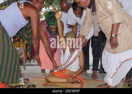 Upanayana sanskara ceremony in progress. Traditionally, this ritual was for 7, 9, and 11 year olds in South Asia, but is now practiced for all ages. Stock Photo