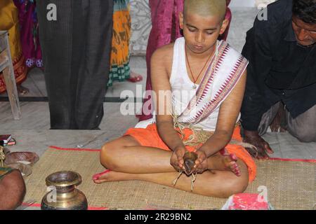 Upanayana sanskara ceremony in progress. Traditionally, this ritual was for 7, 9, and 11 year olds in South Asia, but is now practiced for all ages. Stock Photo