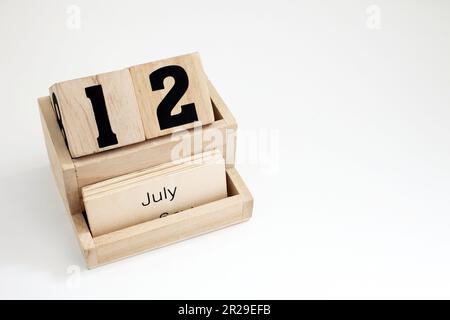 Wooden perpetual calendar showing the 12th of July Stock Photo