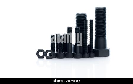 Black bolts and nuts isolated on white background. Industrial fasteners. Hardware tools. Stud bolt, hex nuts, and hex head bolts. Threaded fastener Stock Photo