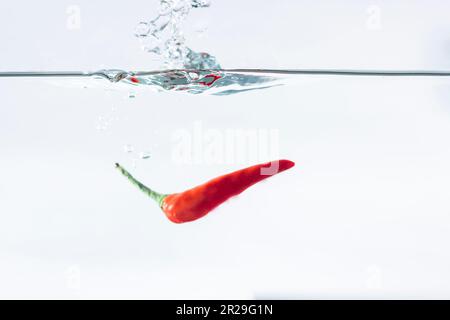 Red chilli, water splashes, solated on a white background Stock Photo ...