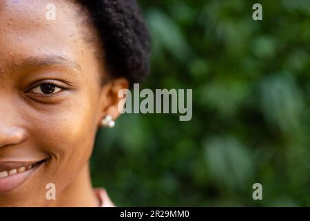 Closeup portrait of smiling african american female architect against plants, copy space Stock Photo