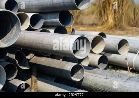 Dirty plastic pipes. construction waste plastic. Background of big plastic pipes used at the building site Stock Photo
