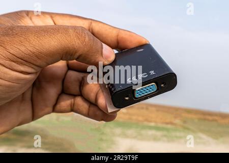 Close-up female vga port showing with hand to data or video transfer pc to monitor with natural background. Stock Photo