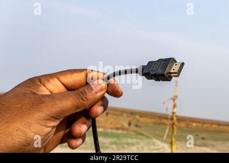 HDMI port with cable showing on hand with natuaral background. Stock Photo