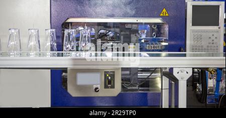 Plastic cup product from plastic injection molding press machine. Industrial manufacturing Stock Photo