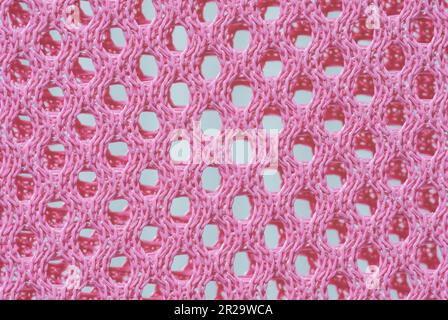 Macro texture of pink color on the mesh part of the sitting chair Stock Photo