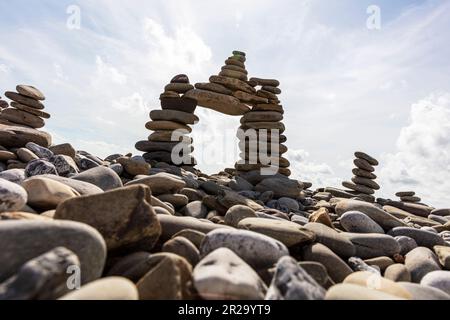Rock Cairns, Amroth, Wales  Cairns are man-made rock piles that are used for navigational purposes in hiking. Rock cairns are human-made stacks, mound Stock Photo