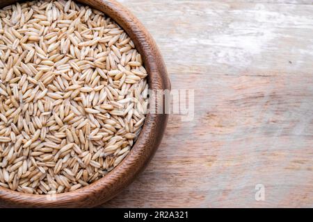oat seeds in a black plate isolated on white background top view Stock Photo