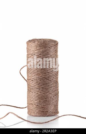 Jute rope for wrapping gifts and various crafts. A coil of rope on a white background. Isolate. Stock Photo