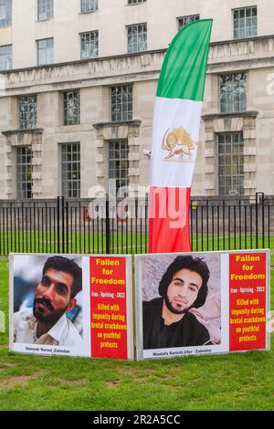 Whitehall, London, UK. 17th May, 2023. A Stop Execution in Iran Protest was held opposite Downing Street in London today. The protesters are calling on the Member States of the United Nations, including the UK,  to help change the 'Religious Dictatorship' Iranian regime. Photographs of those killed in Iran were put along a red carpet. Credit: DLeLife/Alamy Live News Stock Photo