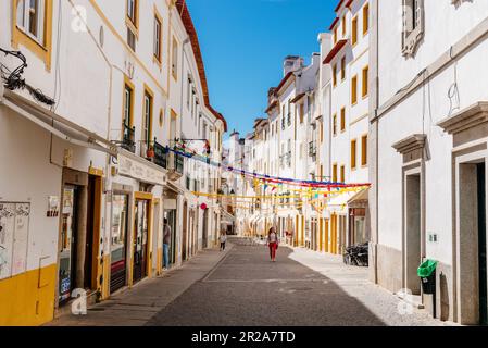 Evora, Portugal - June 30, 2022: Street in the old town with typical whitewashed houses with balconies. Alentejo, Portugal Stock Photo