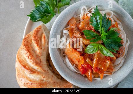 Hot Uighur dish served with herbs and spices. Stock Photo