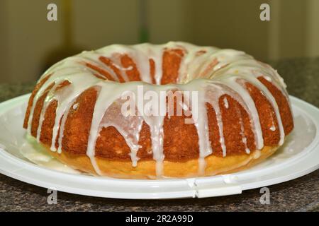 A freshly baked lemon cake with icing. Stock Photo