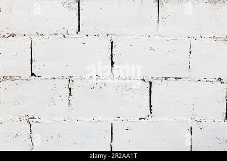 White and rough structure made with blocks. The wall looks old and abandoned. Horizontal. Stock Photo